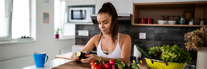 Woman in athletic wear preparing food